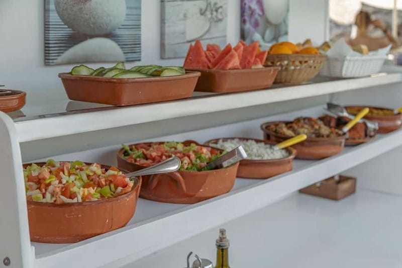 Cala Rajada: Boat Excursion with Drinks and Food - Languages, booking flexibility, and private groups